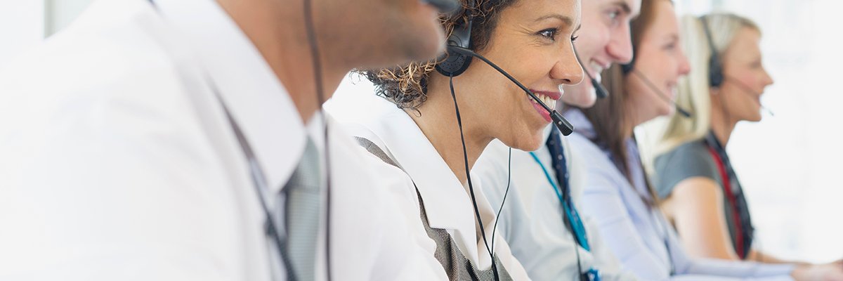 Business people talking on headsets in office